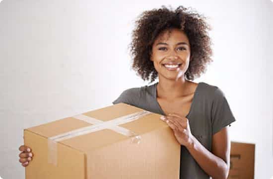 Image: a woman with a box ready to move.