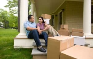 Image shows a family moving into a new home.
